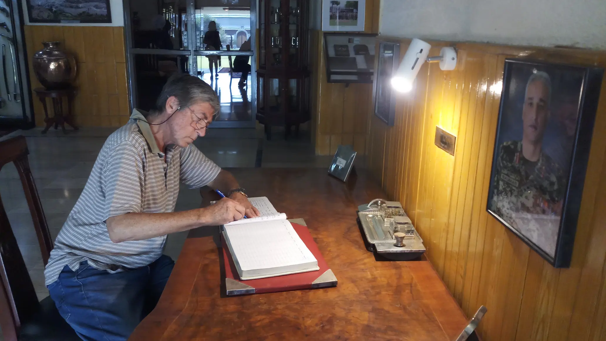 Charles Barker, tourism expert and author signing the guestbook at the Khyber Rifles Mess