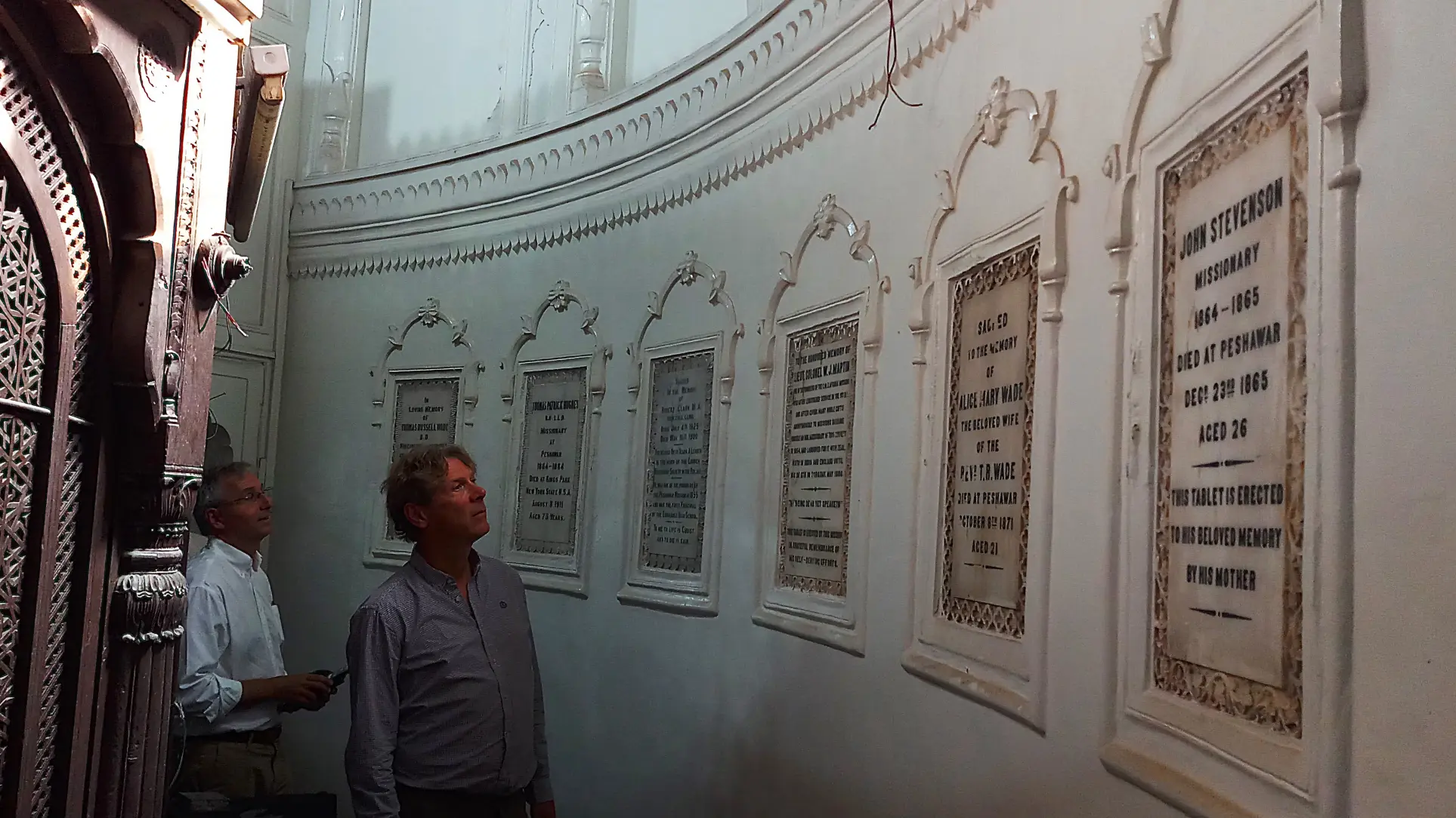 Foreign tourists view the memorials in the ambulatory of the All Saints Church